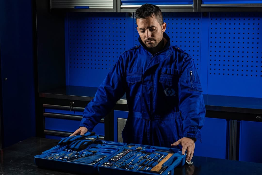 Mechanic examining a complete King Tony tool set on a workshop bench