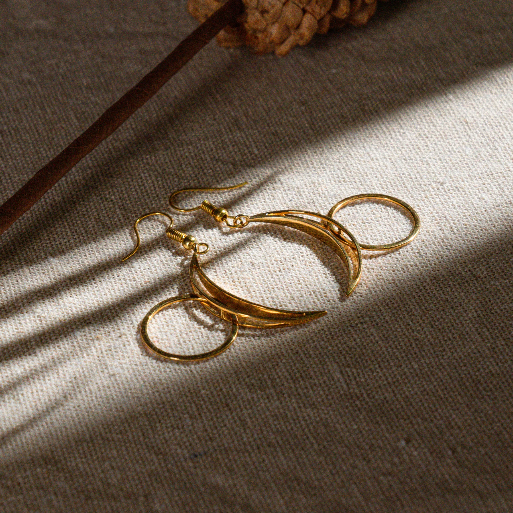 Gold jewelry photographed on textured fabric