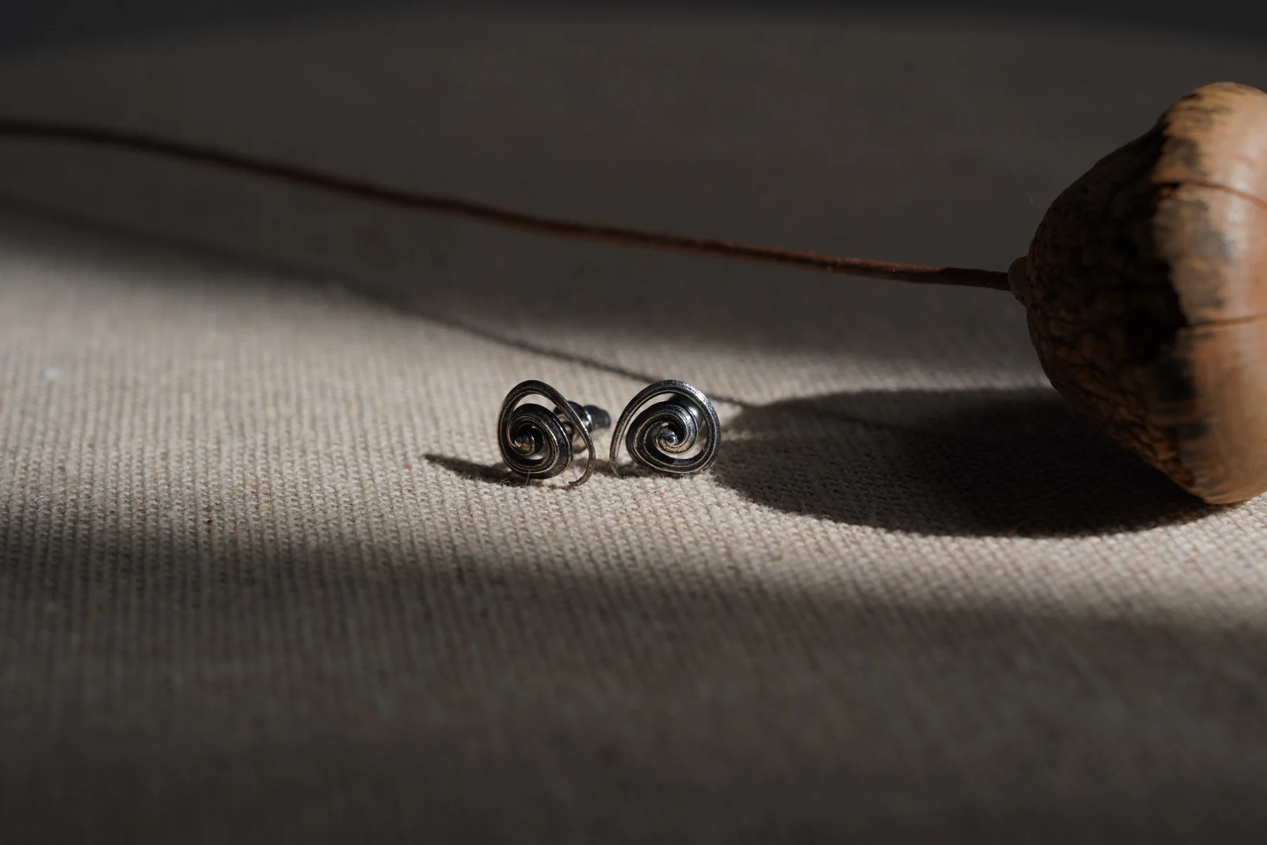 Silver earrings in a natural-light still life