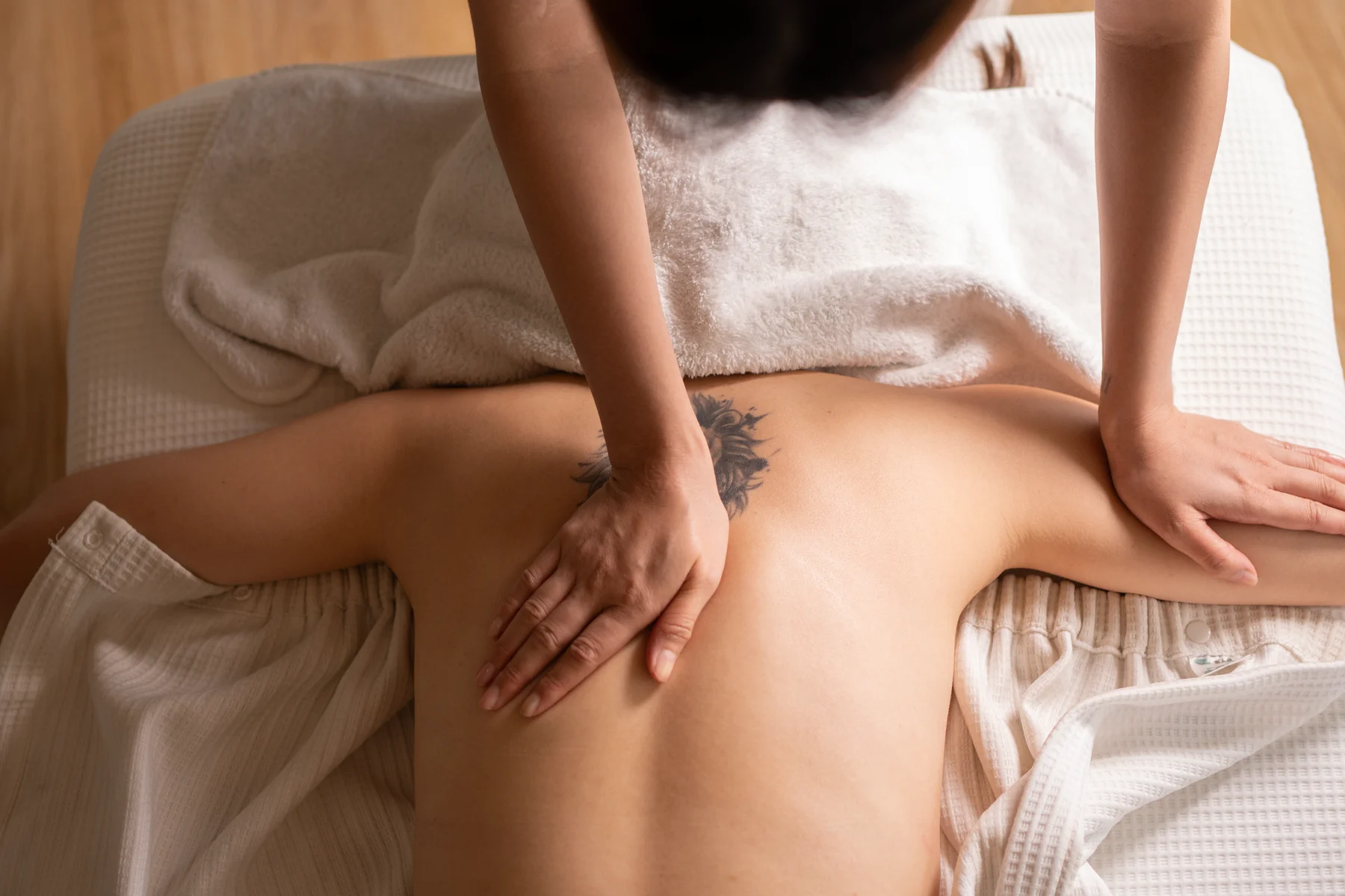 Massage therapist working with a client at MimiStudio