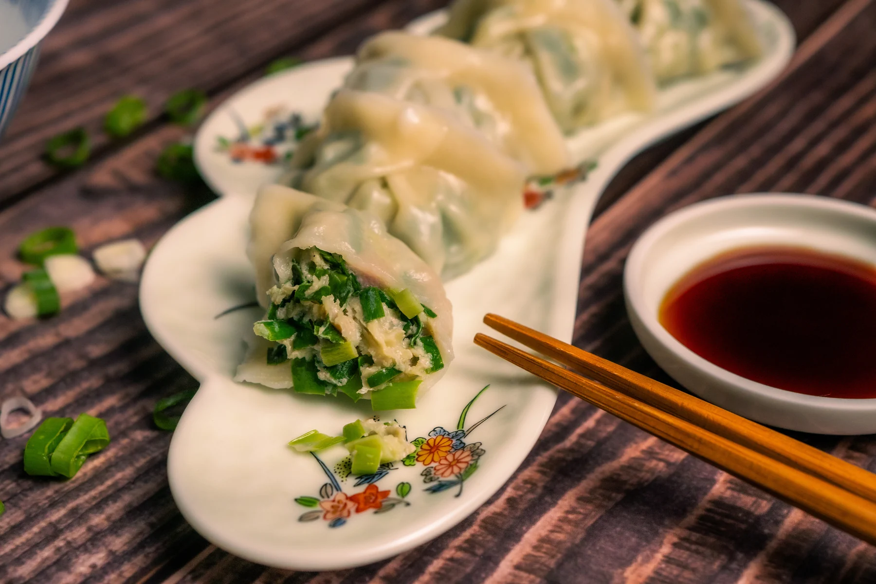 Yuan Bao Dumplings plated with sauce