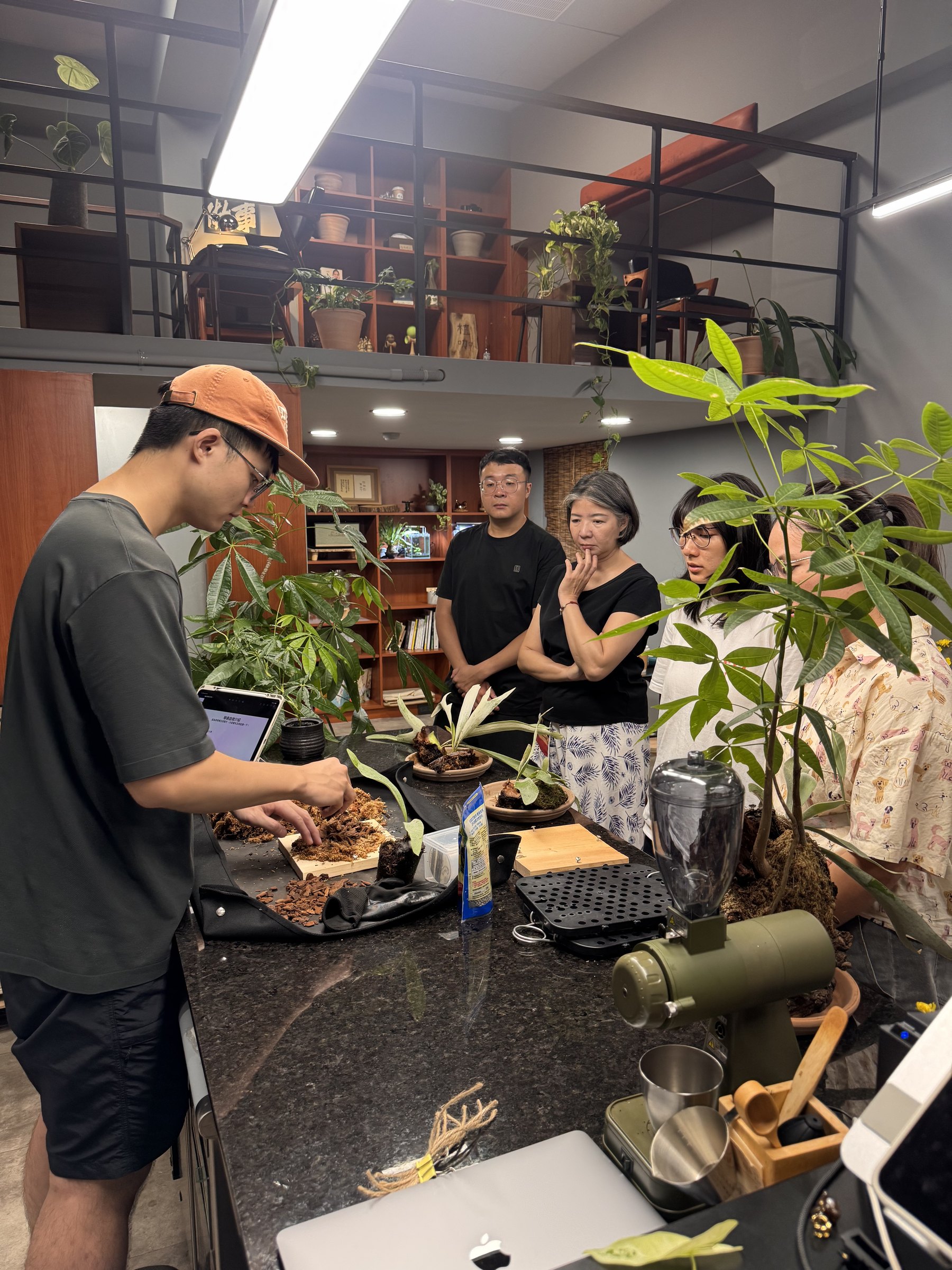 A workshop demonstration surrounded by plants at Plants Cafe