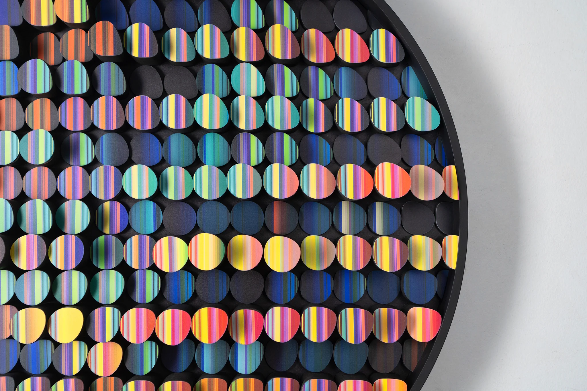 Close view of colorful textile elements arranged inside a circular frame