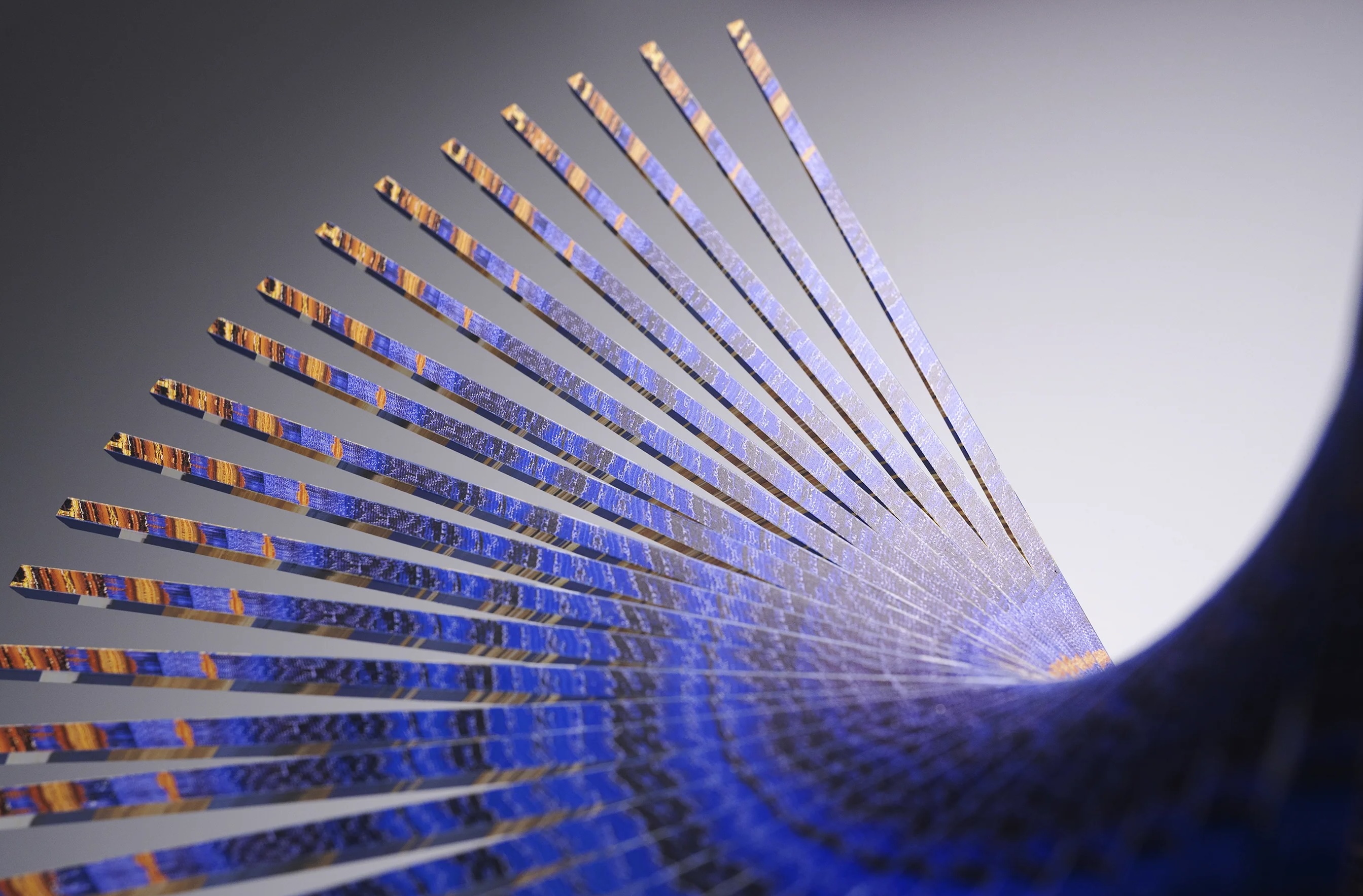 Fan-shaped sculptural artwork with blue and orange patterned strips